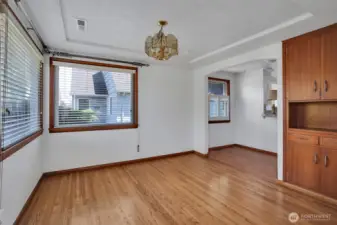 Dining room with a peak into the kitchen eating space, don't miss the original built ins!
