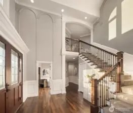 The entryway has soaring ceilings and abundant natural light.