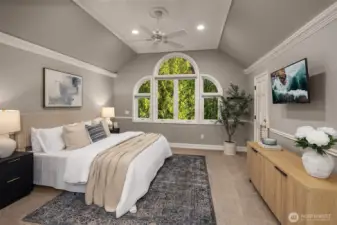 The primary bedroom has vaulted ceilings and two walk-in closets.