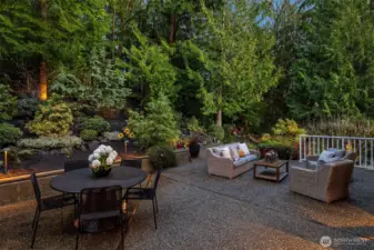 The back patio is filled with soothing sounds as the waterfall runs into the upper pond.