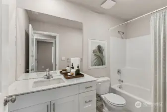 Secondary bathroom features bathtub. Huge island! Pictures are for example only.