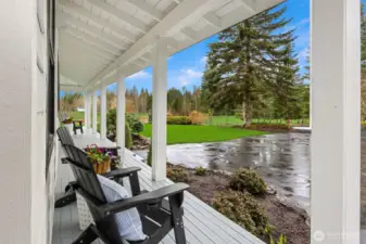 Quintessential covered wrap around deck to relax on this Pacific Northwest Retreat.