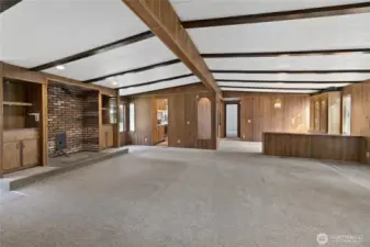 View from hallway looking at living room with built-ins and ready for your woodstove or pellet stove.