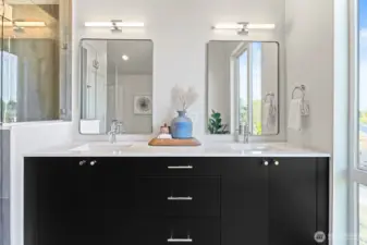 Sleek dual-sink vanity, custom mirrors, and designer lighting add function and flair to the primary suite experience.