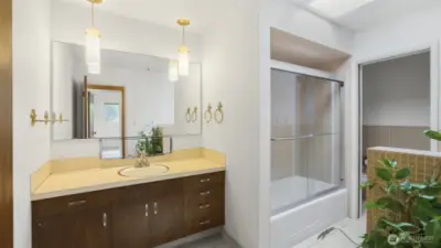 Bathroom features glass enclosure for the shower & tub, separate water closet, & a skylight.