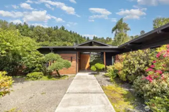 Home is surrounded by lush greenery from every corner of this property.