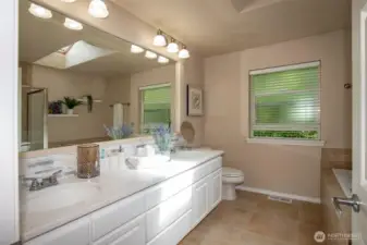 Primary Bath with Double Sinks, Stone Counters, Soaking Tub & Separate Shower & Tile Floors.