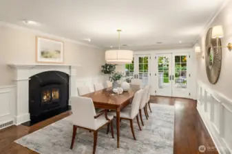 Living flows directly into formal dining, with fireplace and the first 2 sets of French doors out of 7.