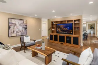 Kitchen flows right into the cozy family room.  Great space to gather and relax.  On the left of the built in is a back staircase leading right to the Primary Bedroom.