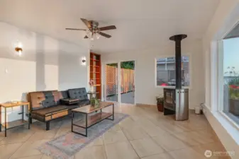 The living room offers a comfortable and cozy space to gather around the modern free-standing fireplace.