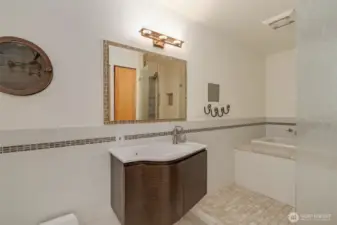 Spa like bathroom with custom tile and handsome fixtures.