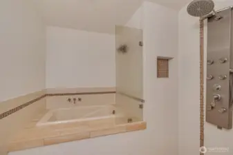 Luxurious walk-in shower with unique Japanese soak tub to relax and unwind after a day at the beach.