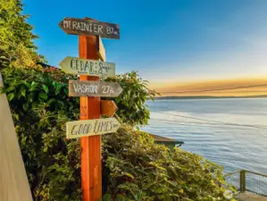 A whimsical sign gives direction to your beach house paradise.