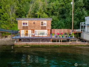 The home backs up to a lush green backdrop for a secluded feel.