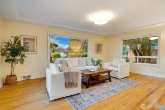 Front living room with tiered ceiling. All windows are dressed with blinds privacy blinds that open both up and down.