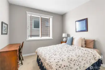 Bedroom two has a large window overlooking the side of the home and a second door leading into the full continental bath.