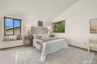 Oversized primary suite has vaulted ceilings