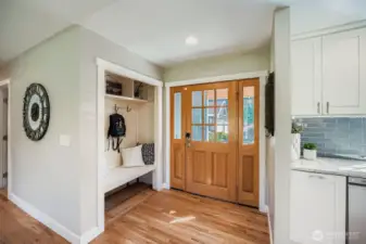 Entry has a bench and closet to store your shoes and packs.
