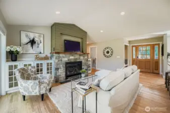 BUiltt-in bookshelf cabinets and a large rock fireplace warms the room.