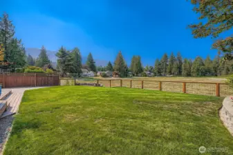 The yard is fully fenced with a gate to the lake and a fire pit at the waters edge.