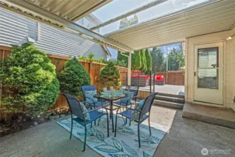 Covered back porch with skylight panels is the perfect spot for al fresco dining and entertaining.