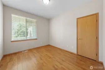 Bedroom 1. Window looks out to the front yard.  Door is to the closet.