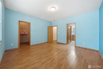 View from the corner of the primary bedroom of the walk-in closet and 5-piece bathroom.