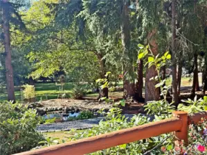 Charming pond seating area views from deck.  This pond area is wonderful to sit and enjoy a morning coffee in the sun, or an evening beverage in the shade.