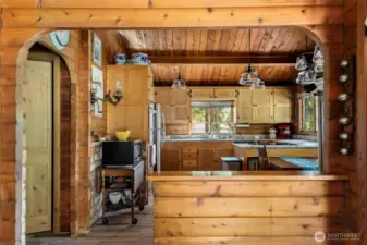 The updated kitchen is open to the Great Room.  To the left is the hallway to the laundry area, pantry/storage, the 2nd bedroom with it's own 3/4 bathroom, and the back door to the dog run, and access to the yard areas,