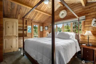 Primary bedroom has vaulted ceilings, and access to the west facing deck.  Beautiful wood doors thru-out this home too.