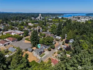 This aerial shot shows the perfect location just a block away from two local gems. Olympia Baking Company, a gluten-free bakery known for its scones and savory treats, is just a short stroll away. Similarly, Frog Pond Grocery, with its iconic green-painted facade and giant frog sign, is a food lover’s paradise offering everything from locally sourced produce to artisanal cheeses and organic meats. It’s a neighborhood that offers convenience and delicious options right around the corner.