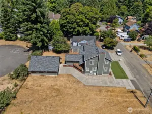 This level, paved driveway leads you directly to the 4-car detached garage, offering ample space for parking or projects. For now, the vacant lot next door adds to the open, airy feel of the property. While it may be developed by another owner down the road, it’s a bonus feature that enhances the sense of space here today.