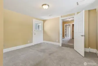 The back bedroom in Unit A is ready to become your personal sanctuary. With its own 3/4 bathroom and an exterior door that leads straight to the deck, it has everything you need. Accessed through the den, it features oatmeal-toned carpeting, warm paint, and fresh white trim. The layout is anything but ordinary, offering options to suit whatever your lifestyle demands, whether that’s a primary bedroom or something totally different.