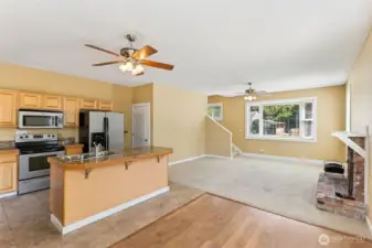 Unit B’s kitchen is a perfect blend of style and function. The tile flooring in tan stone tones sets the mood, while the kitchen island with a sink and dishwasher makes prep and cleanup a breeze. Stainless steel appliances, warm wood-tone shaker cabinetry, and a glass-topped electric stove add both charm and practicality. No more worrying about gas being left on, and the French door fridge with water and ice dispenser is ready for all your chilled beverages.