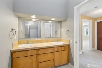 Unit B’s upstairs 3/4 bathroom combines style and privacy in all the right ways. Vaulted ceilings and high windows flood the space with natural light while keeping things private. The long vanity with dual sinks gives you plenty of space, and the tile shower with a glass door adds an extra touch of elegance. Plus, the toilet is tucked behind the shower for added privacy too!