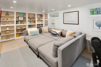The lower level offers fantastic flexibility with a cozy media room (or optional fourth bedroom), laundry area, abundant storage, and a hidden speakeasy-style room tucked behind custom built-ins—a perfect space for entertaining or relaxing in style.