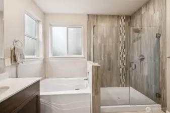 Frameless glass shower, soaking tub & lots of natural light in primary
