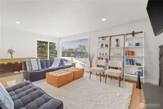 Main floor living room with a dramatic fireplace designed to enjoy with access to the upper deck