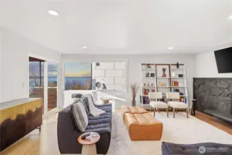 Formal living room with dramatic gas fireplace overlooking the sound. Ready to unwind at the end of the day