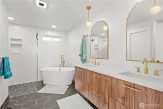 Spa inspired primary bath on main floor with dual sinks, soaking sub and walk in shower.