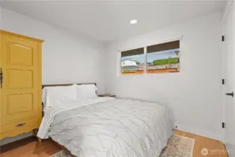 Second bedroom on the main floor is generous in size and has an adjacent full bath