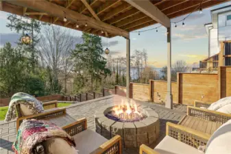 Back patio is designed to be outside with custom pavers, a gas firepit and lighting, it invites you to stay awhile