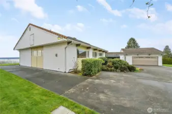 This beautifully maintained home sits on an expansive 17,000+ sq ft lot, offering exceptional space, privacy, and versatility. A generous driveway leads to a spacious 2-car garage and provides ample parking for a boat, RV, and all your recreational toys—plus plenty of room for guest parking. Framed by manicured landscaping and set against a serene water backdrop, the property blends everyday functionality with a peaceful, picturesque setting.