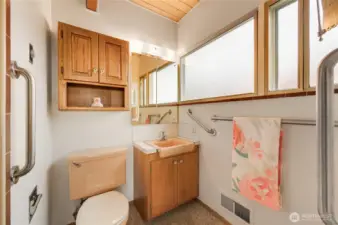 Well-appointed primary bathroom located just off the primary suite, featuring a clean and functional layout with warm finishes, ample storage, and natural light—offering everyday comfort in a private, convenient setting.