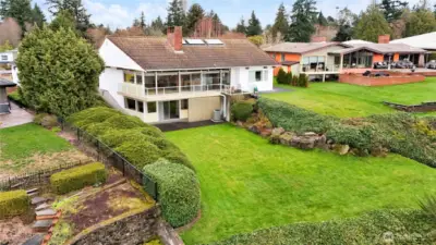 This remarkable residence sits in a coveted enclave along the Puget Sound, offering a lifestyle defined by coastal beauty, peaceful surroundings, and timeless Northwest charm. Celebrated as the Seattle Times “Home of the Month” in 1958, the property has long been admired for its thoughtful design, striking architecture, and connection to the landscape. Expansive lawns, mature greenery, and sparkling water views create an idyllic backdrop, while the home’s elevated position provides a sense of privacy and serenity. A rare opportunity to own a piece of local history in one of the Sound’s most picturesque settings.