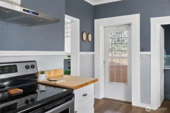 Kitchen with entrance to sun room and full bath