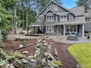 Backyard- level with great new water feature, extended patio with firepit