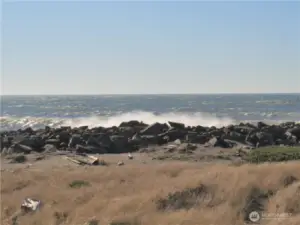 SIT ON YOUR COVERED DECK AND WATCH WAVES ALONG THE ROCK JETTY!