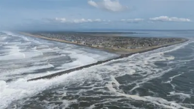 YOU CAN JUST MAKE OUT THE CONDO IN BACKGROUND AS THE DRONE SWINGS AWAY FROM THE OCEAN INTO THE JETTY AND CHEHALIS RIVER!