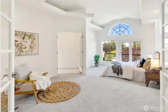 Main floor primary suite features a sitting area and access to the deck